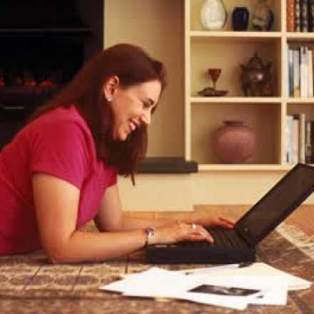 woman lying on the floor looking at her laptop