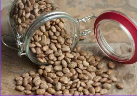 pinto beans spilling from a jar