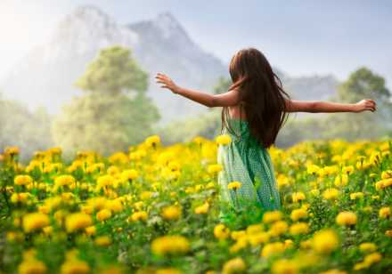 Girl in field of yellow flowers