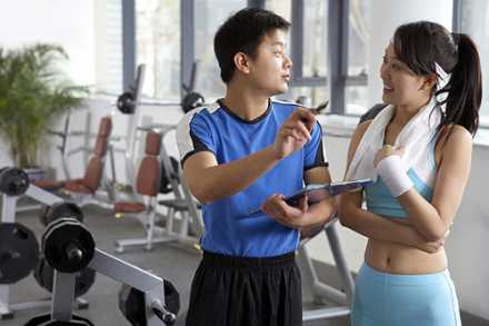 Trainer working with a client at the gym