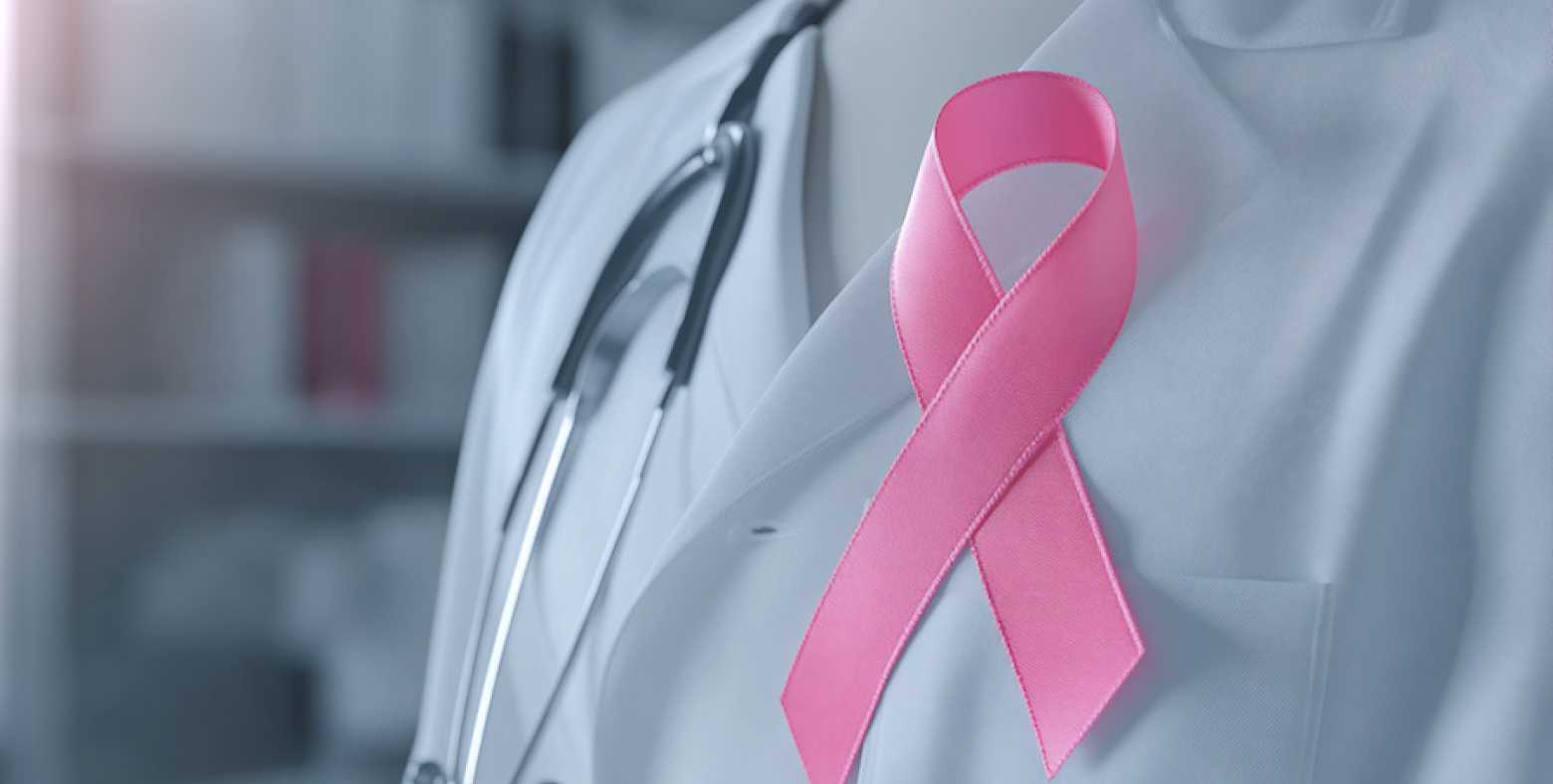 Pink ribbon on Doctor's white lab coat and stethoscope