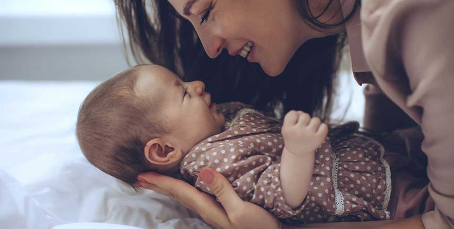 Mom snuggling baby