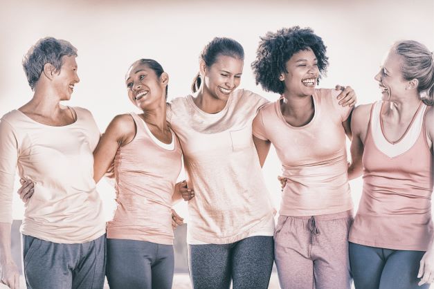 5 women in pink together smiling