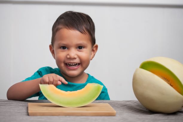 Boy eating fruit