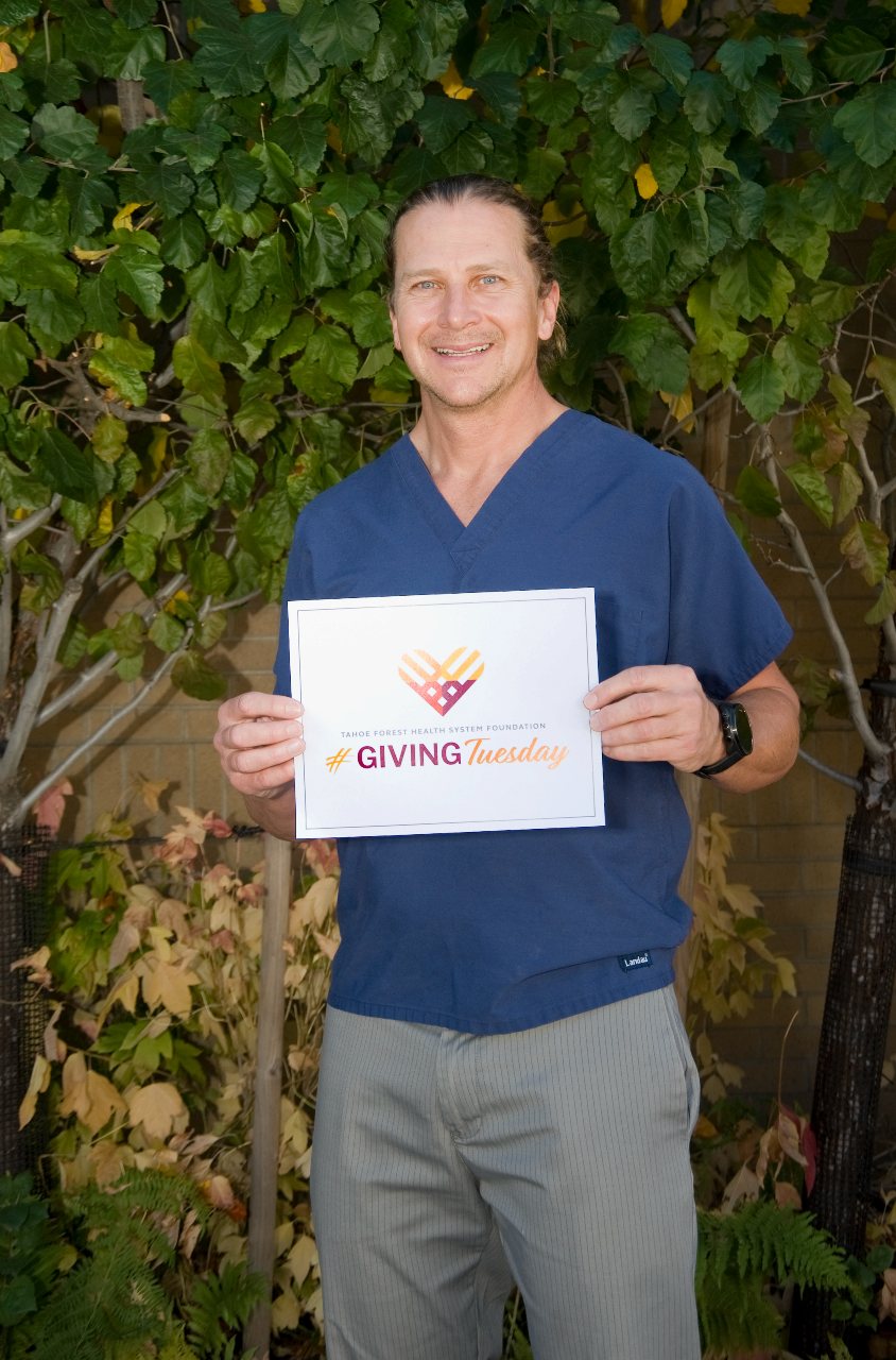 Dr. Rosengreen holding a giving tuesday certificate