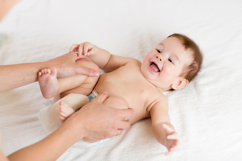 baby on bed laughing