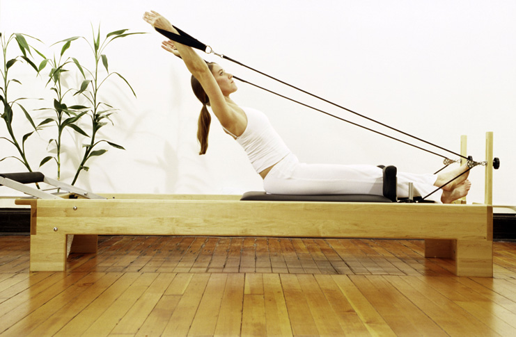 woman on pilates reformer