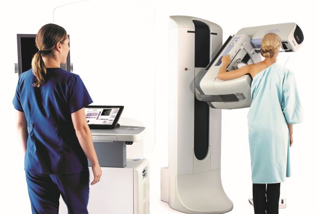 female tech and patient undergoing mammogram