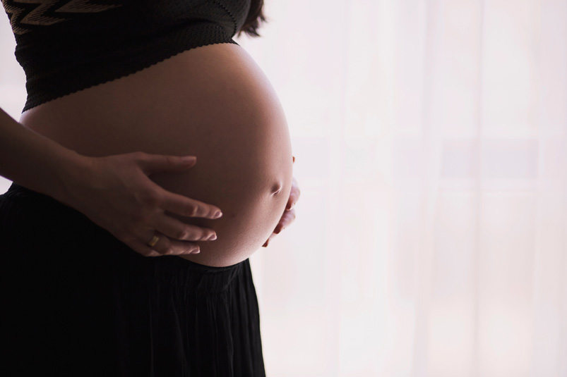 woman holding her pregnant belly