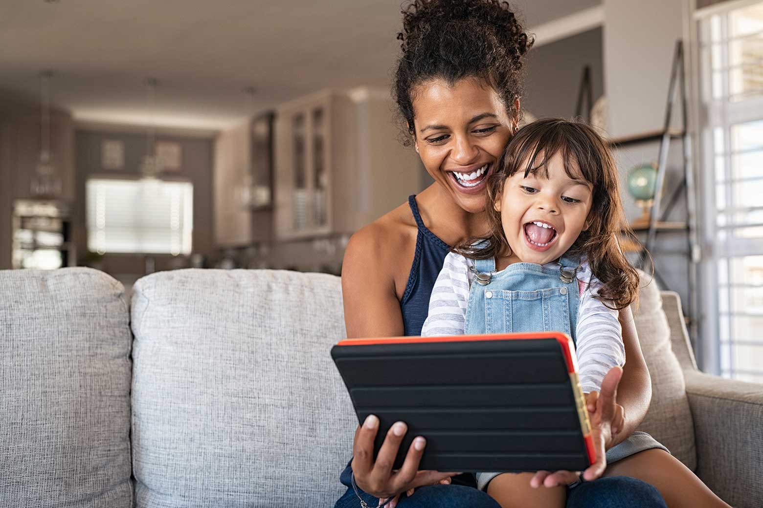 Mom and daughter reading on tablet