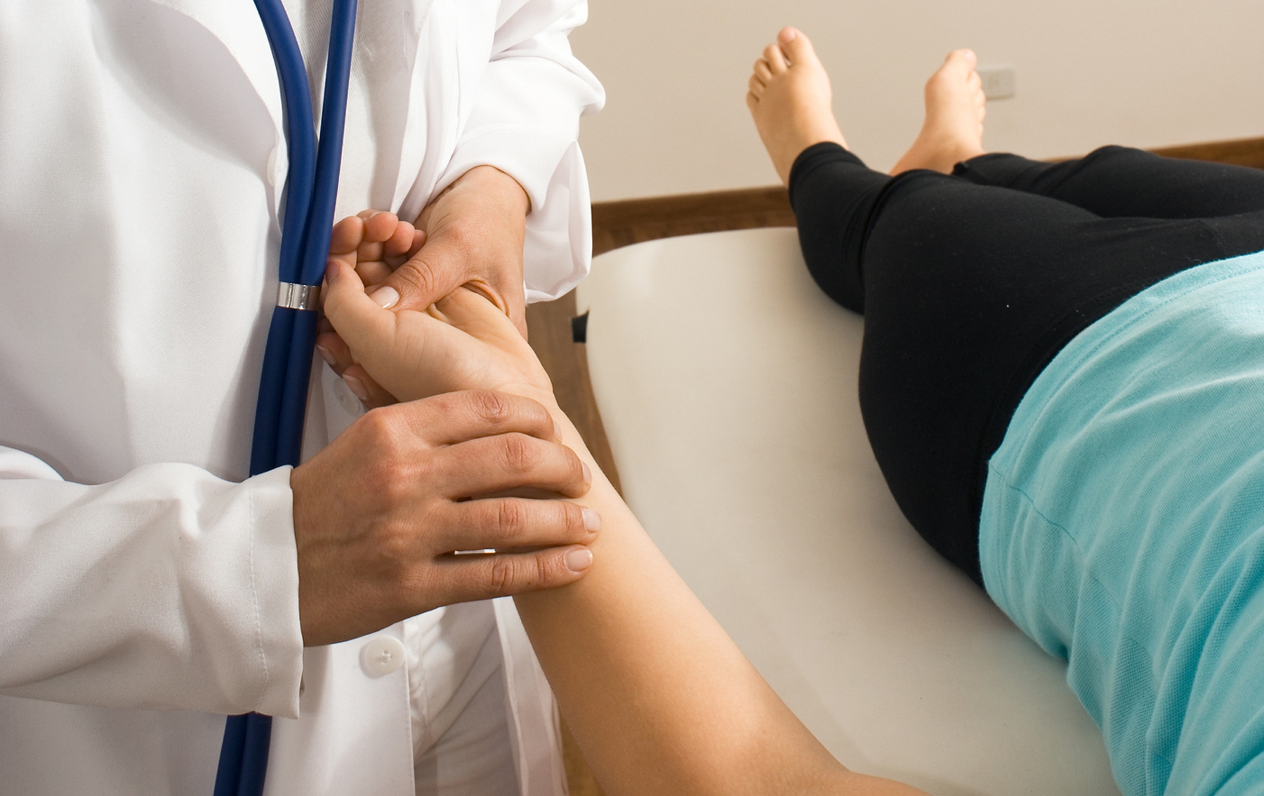 Nurse checks patient's pulse