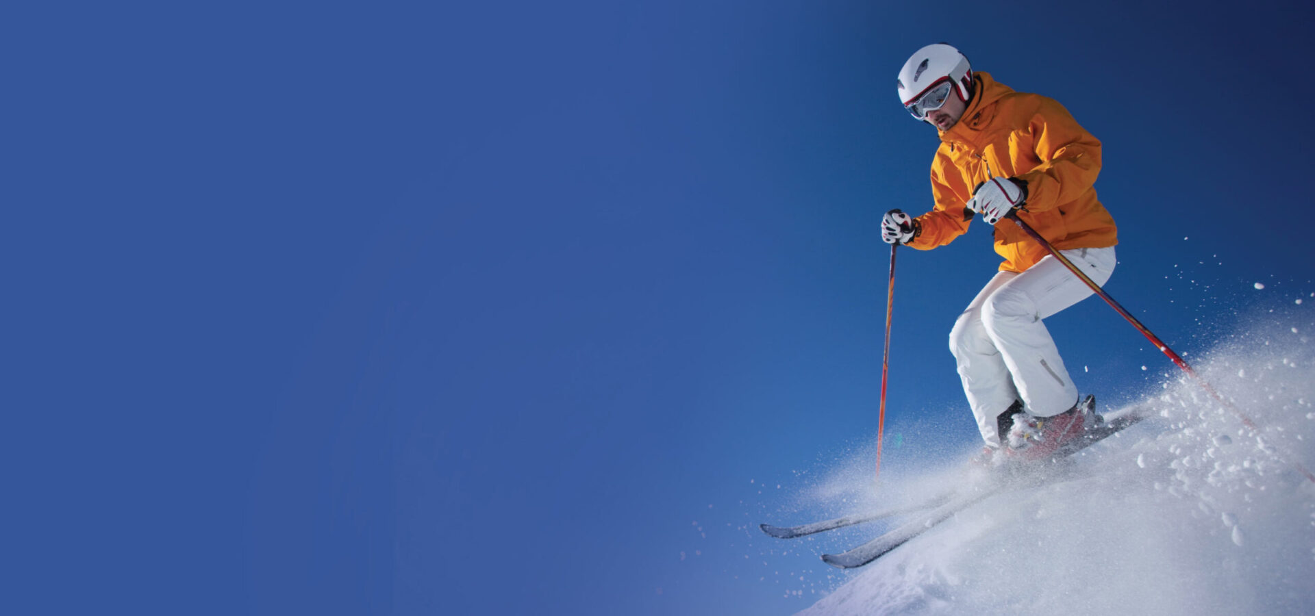 Skier shredding on a bluebird powder day