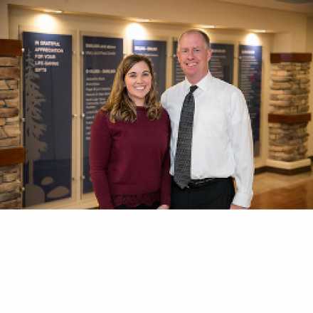 Karli epstein in front of the IVCH donor wall