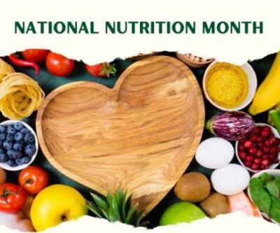 national nutrition month heart shaped wooden bowl surrounded by healthy food