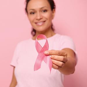 women holding pink breast cancer ribbon