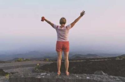 woman holding her arms up